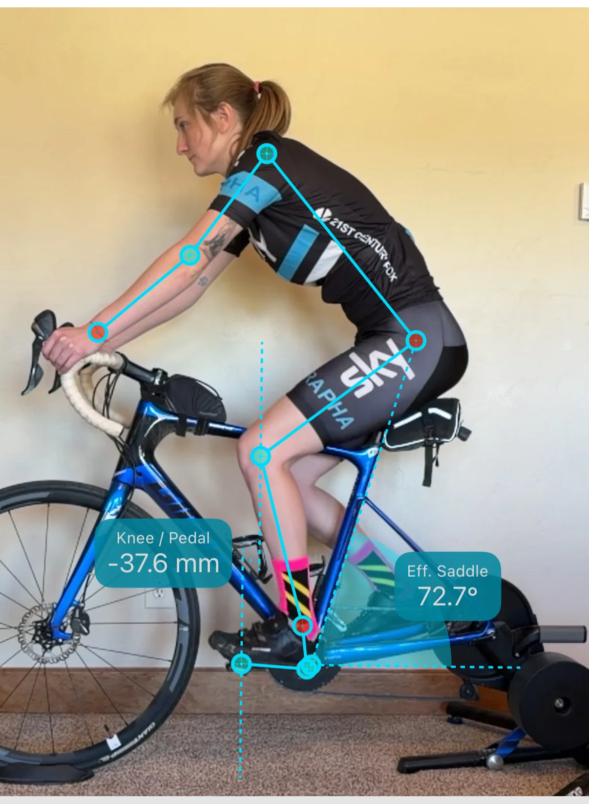 Saddle well back. The legs reach for the pedals, and the app reads the knee 37.6 mm behind.